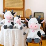 Cute Kawaii Sitting Cow Plush Toy with Heart Eyes and Locket, Soft Stuffed Animal for Kids by Lisbon Toys
