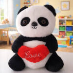 Cute panda soft toy holding a red heart with love text, black and white panda plush stuffed animal for kids, gifting, Valentine's Day, and room decoration.